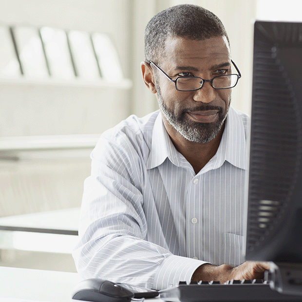 Black man at a business computer