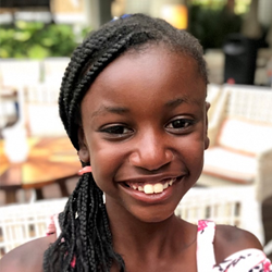 A young girl smiling for the camera.