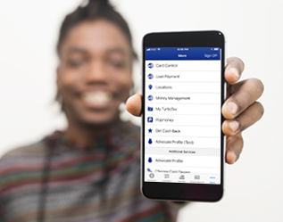 A man holding up a cell phone with a social media app on it.