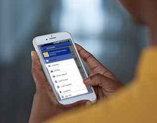 A person holding a cell phone with a school's app on it.