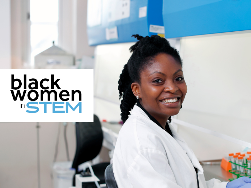 A woman in a lab coat with the black women in stem logo.