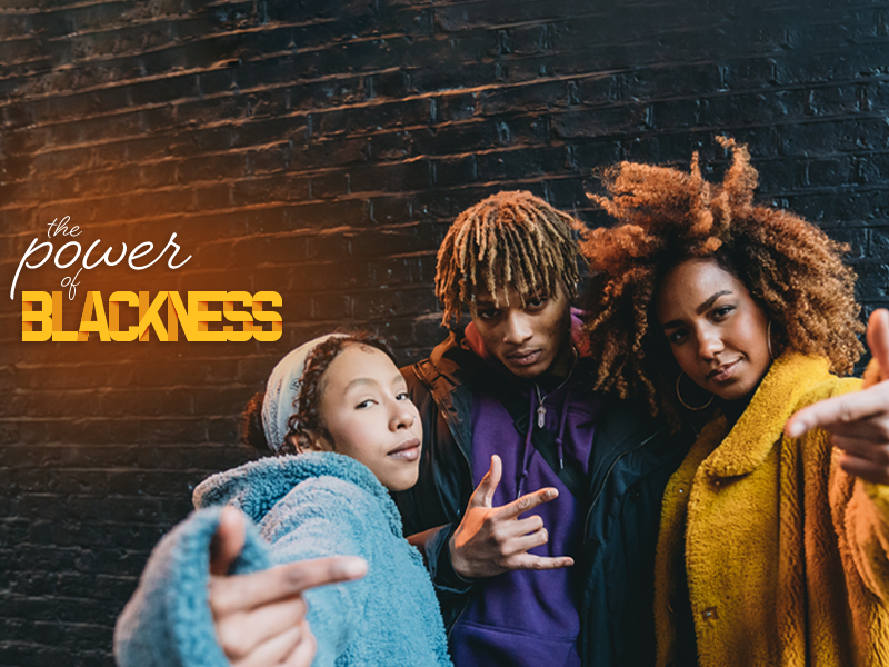 A group of people posing for a photo with the words power blackness.