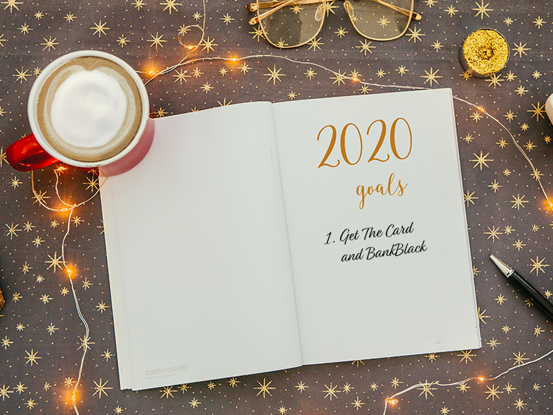 A notebook with the words 2020 goals and a cup of coffee next to it.