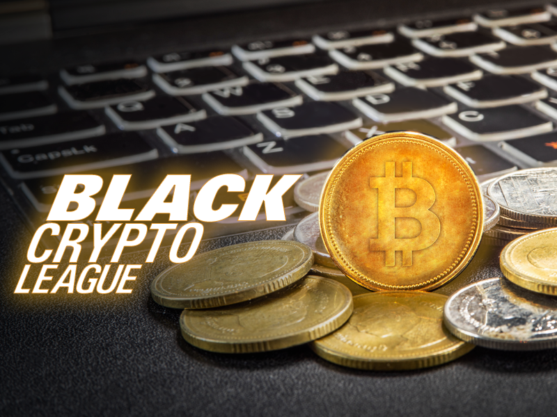 The black crypt league logo with coins on top of a laptop.