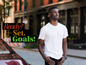 A man standing next to a car with the words ready? set goals.