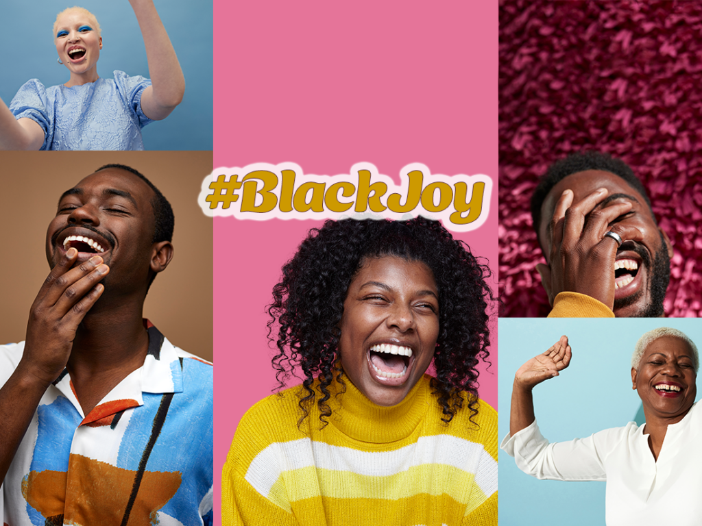 A group of people laughing with the words black joy.