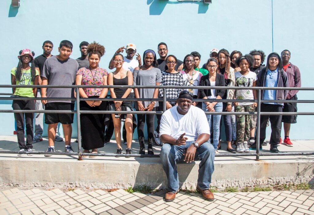 A group of people posing for a photo in front of a building.