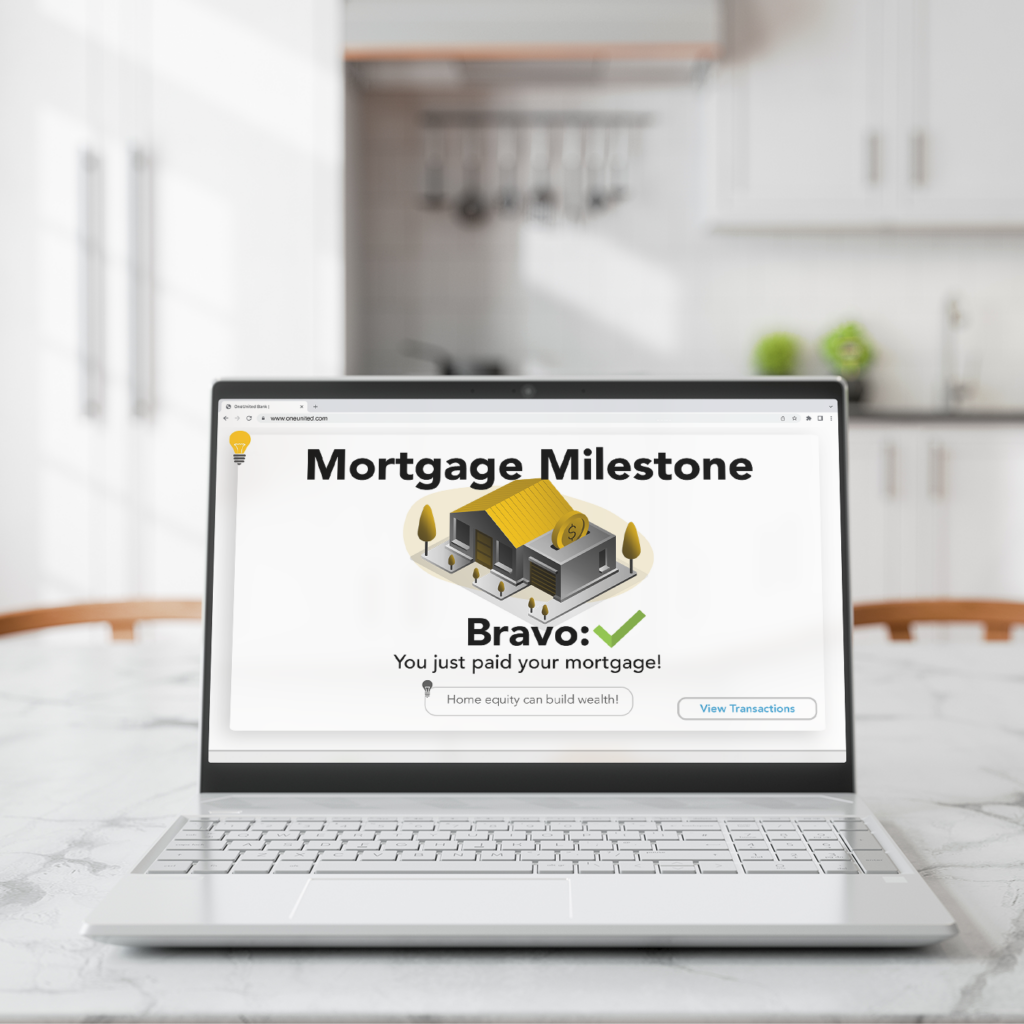 A laptop with a mortgage milestone on the screen indicating that the user paid their mortgage