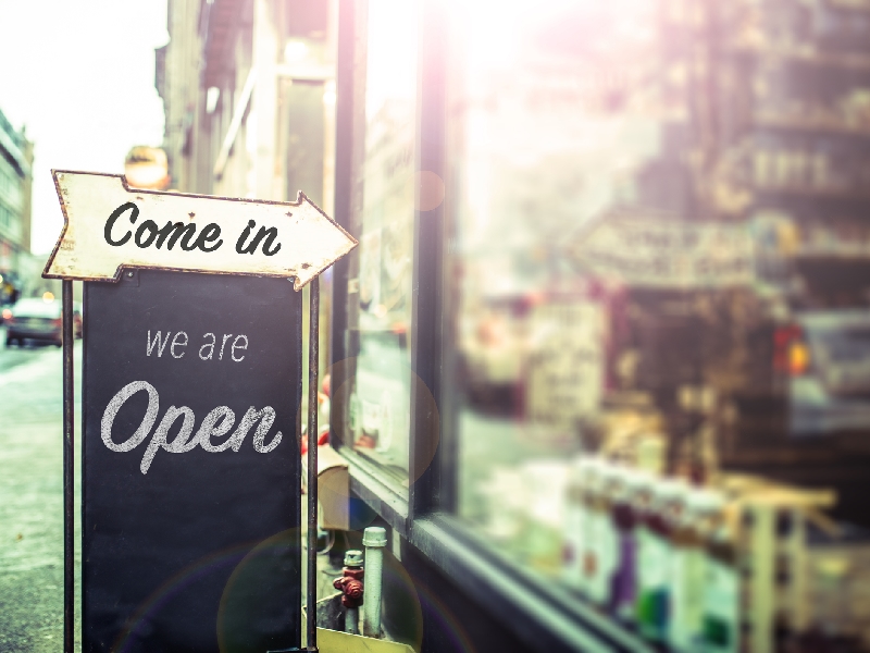 Come In, We're Open Sign On A Glass Door