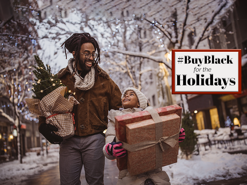 A man and a child holding gifts in a snowy street.