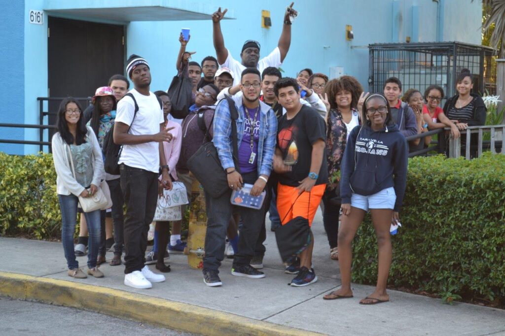 A group of people standing in front of a building.