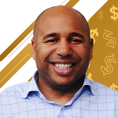 A man smiling in front of a gold background with dollar signs.