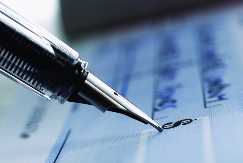 Close Up Of A Fountain Pen Writing On A Check