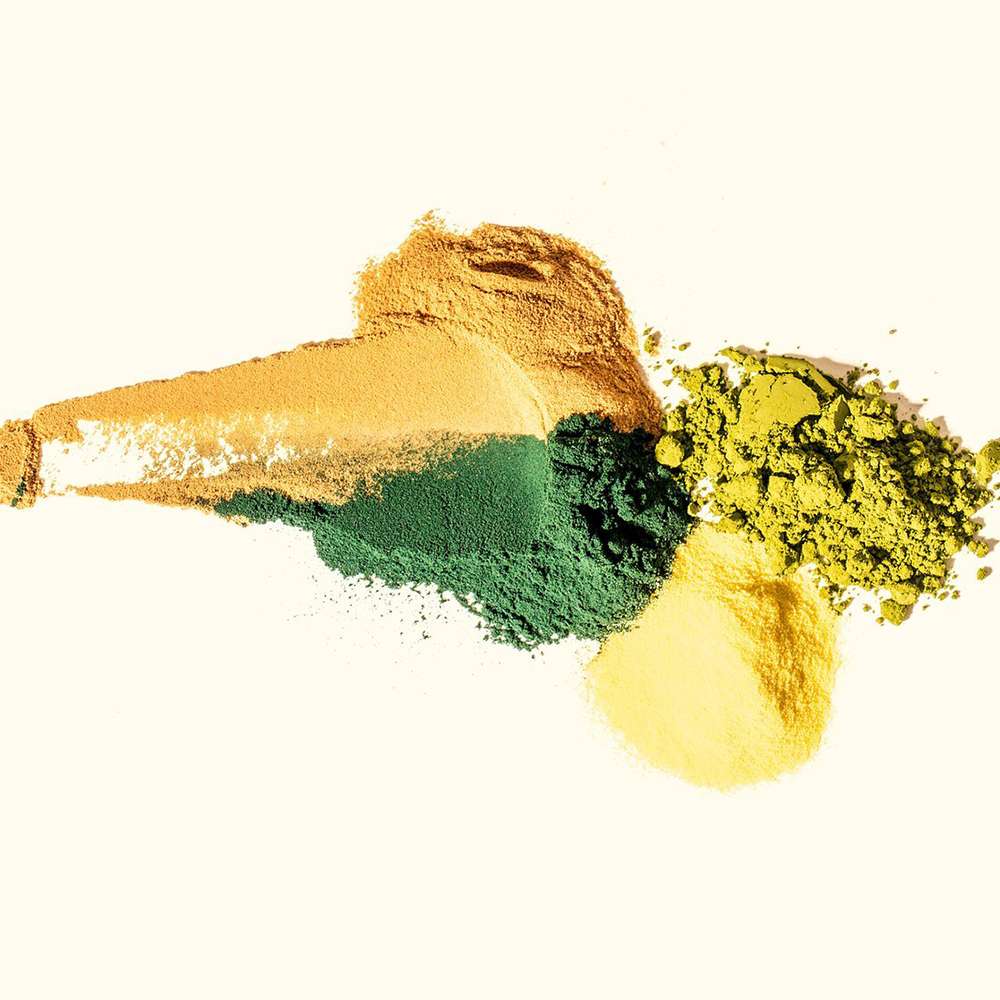 A yellow, green, and blue powder on a white background.