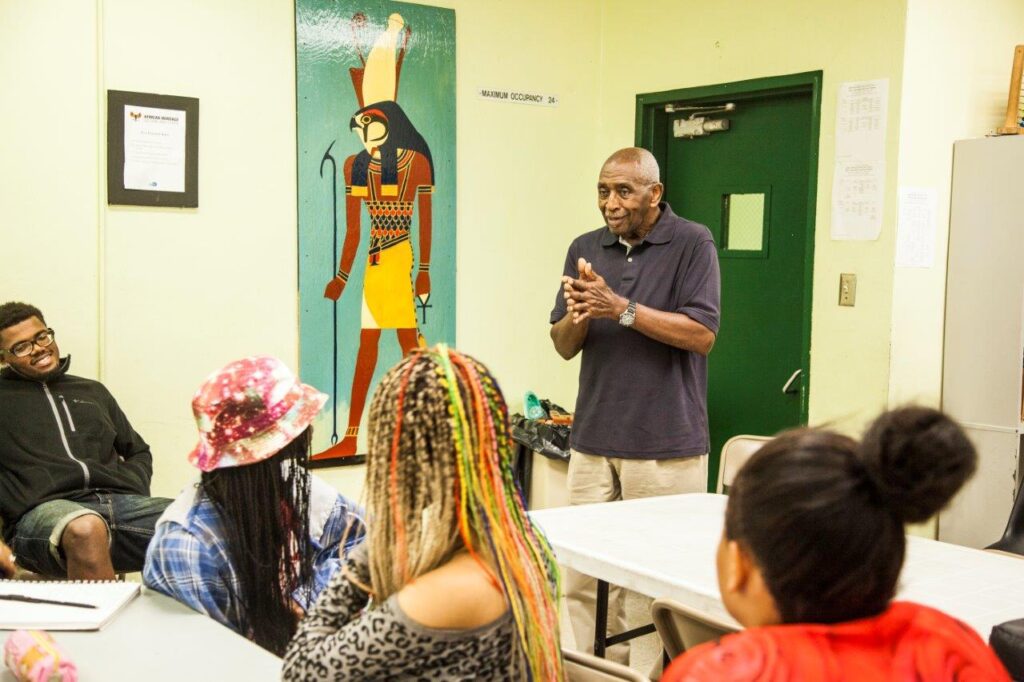 A man speaks to a group of people at a table.