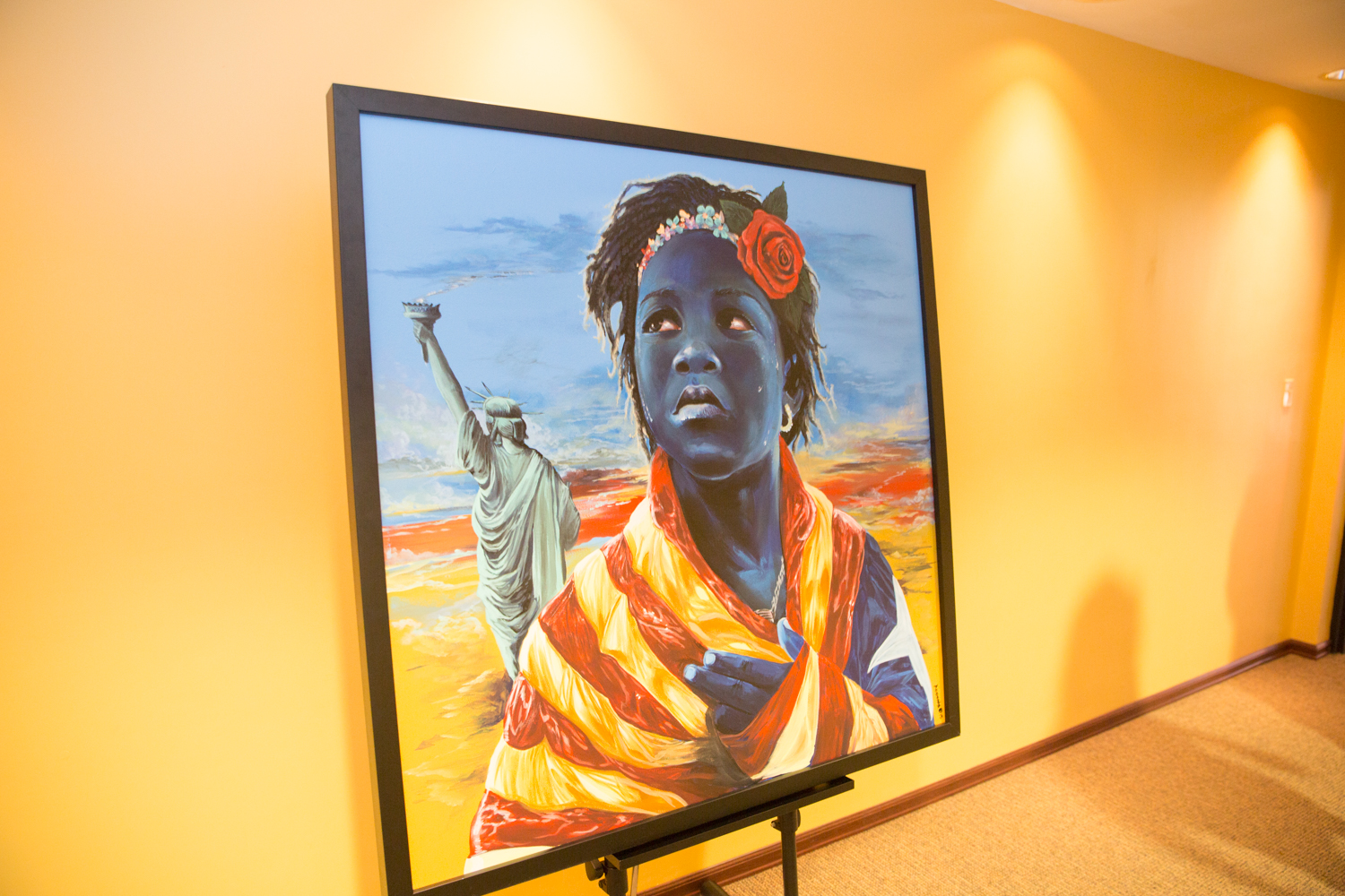 A painting of a black woman is on display in an office.