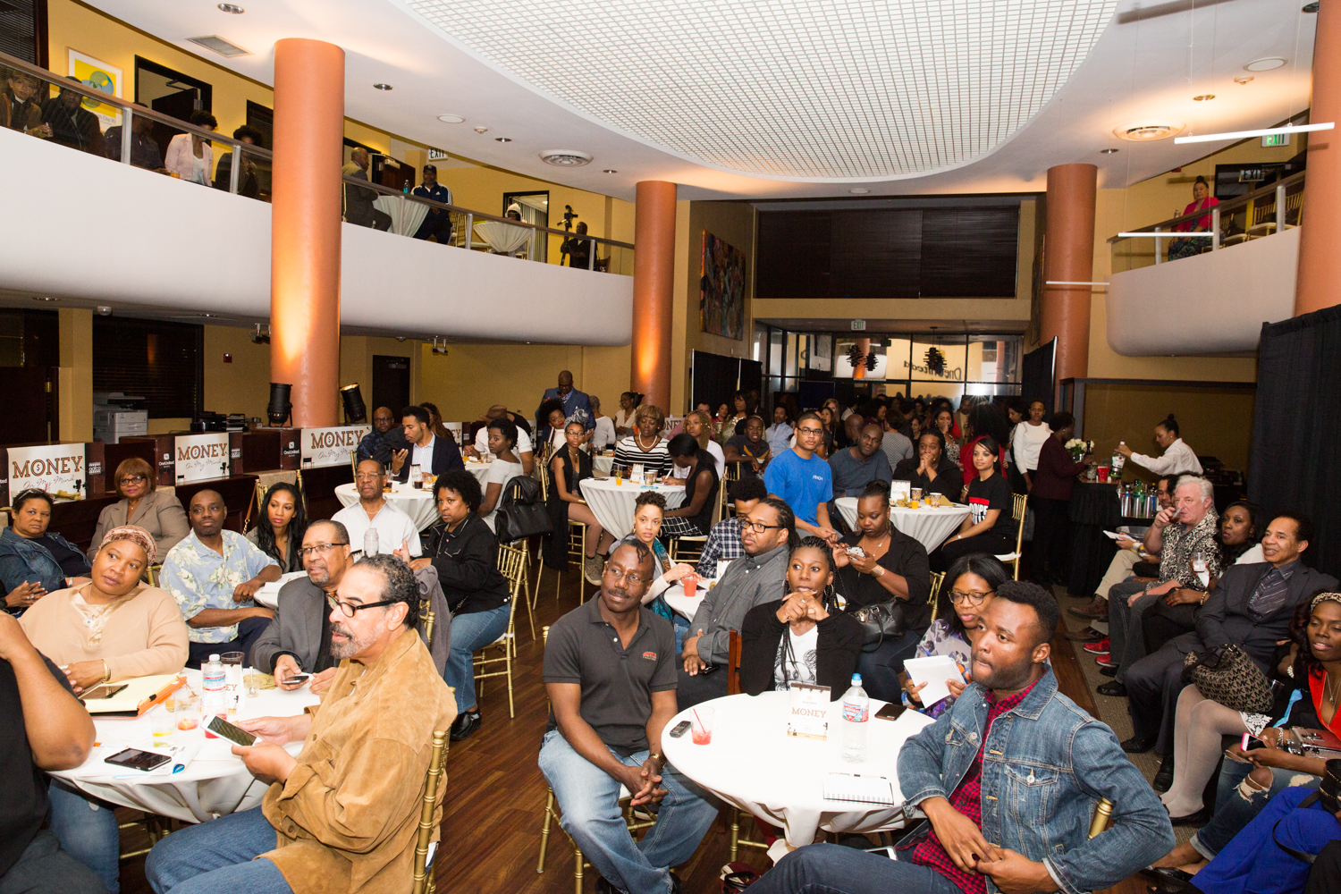 A crowd of people sitting at tables.