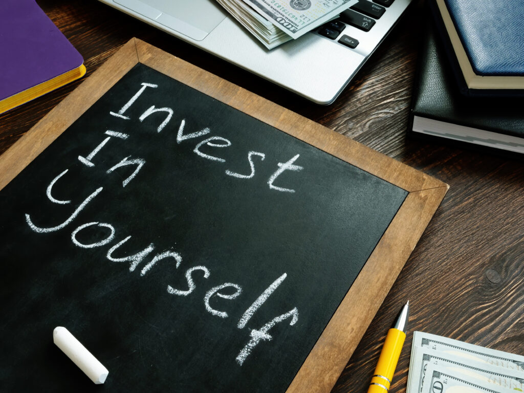 Invest in yourself memo on a small blackboard.