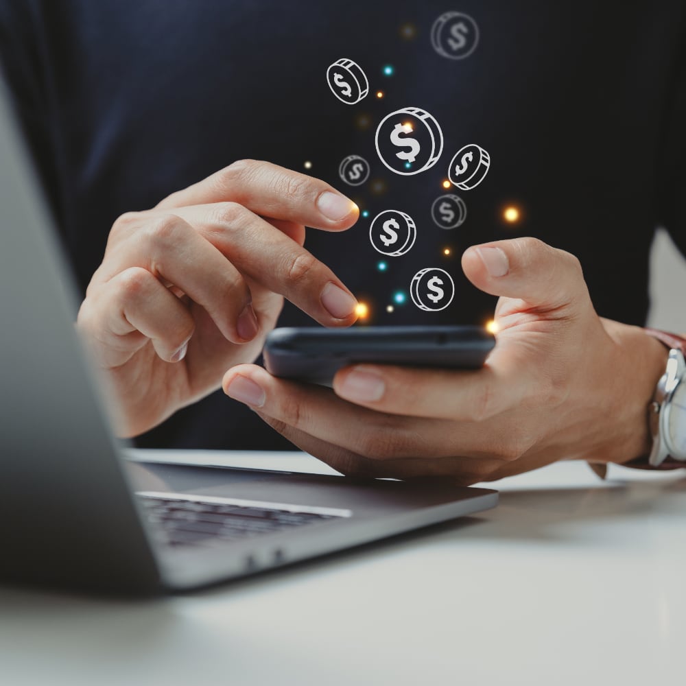 Person typing on their smartphone, with dollar sign symbols floating from the phone