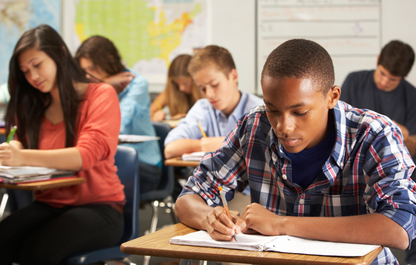 A group of students taking a test in a classroom.