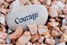 A stone with the word courage surrounded by rocks.