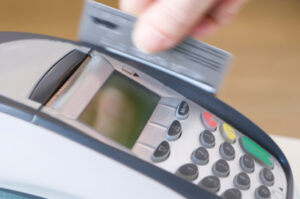 A person inserting a credit card into a machine.