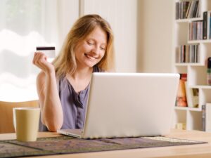 A woman holding a credit card.