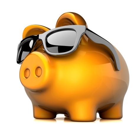 A piggy bank wearing sunglasses on a white background.
