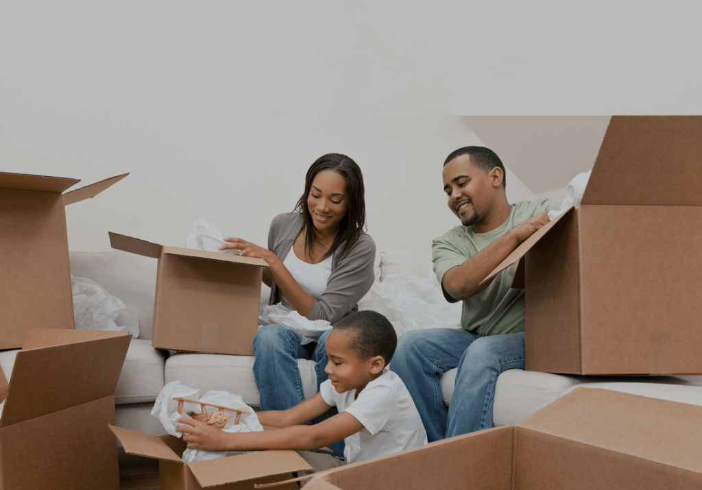 family unpacking boxes in their new home