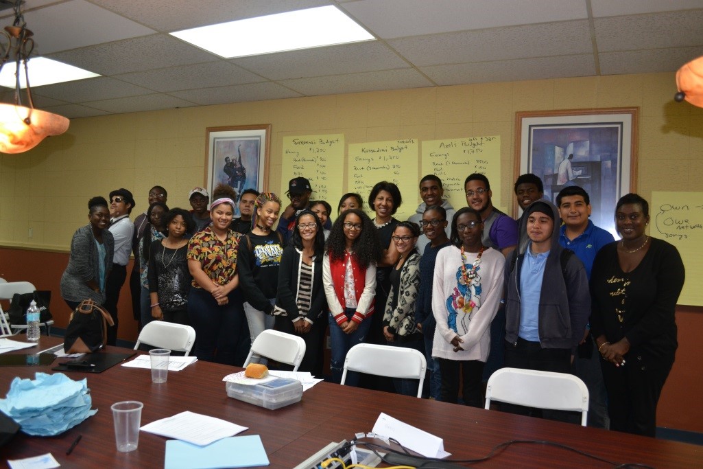 A group of people posing for a picture in a conference room.