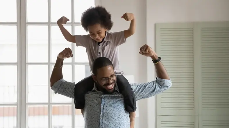 A man and his daughter are playing in the living room.