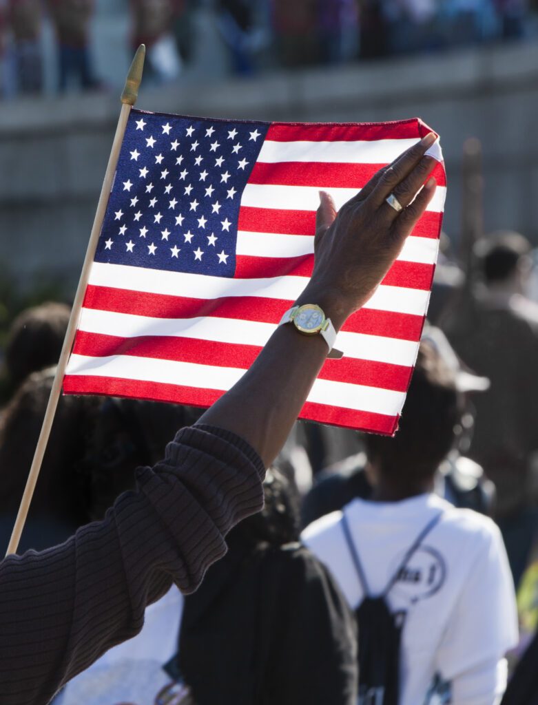 A person waving an american flag.