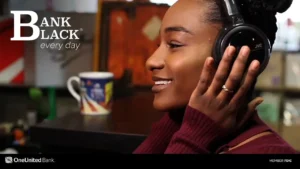 A woman wearing headphones with the words bank black every day.