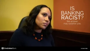 A woman sitting in front of a desk with the words is banking racist?.
