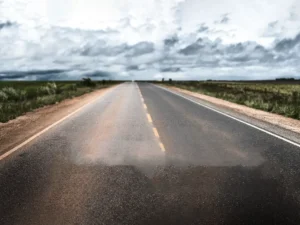 A desolate road under a cloudy sky, devoid of life.