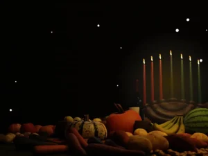 A hanukkah scene with a hanukkah candle and fruits.