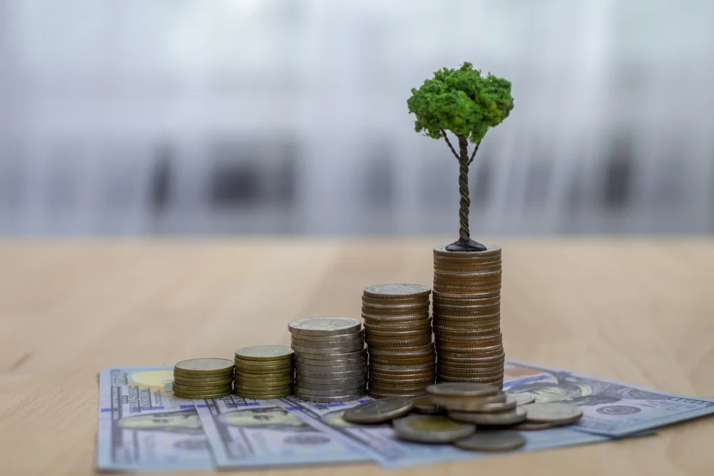 A small tree on top of stacks of coins.