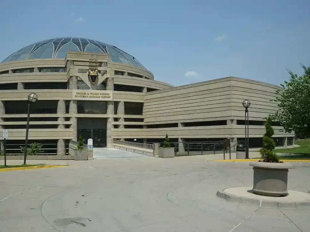 A building with a large dome in front of it.