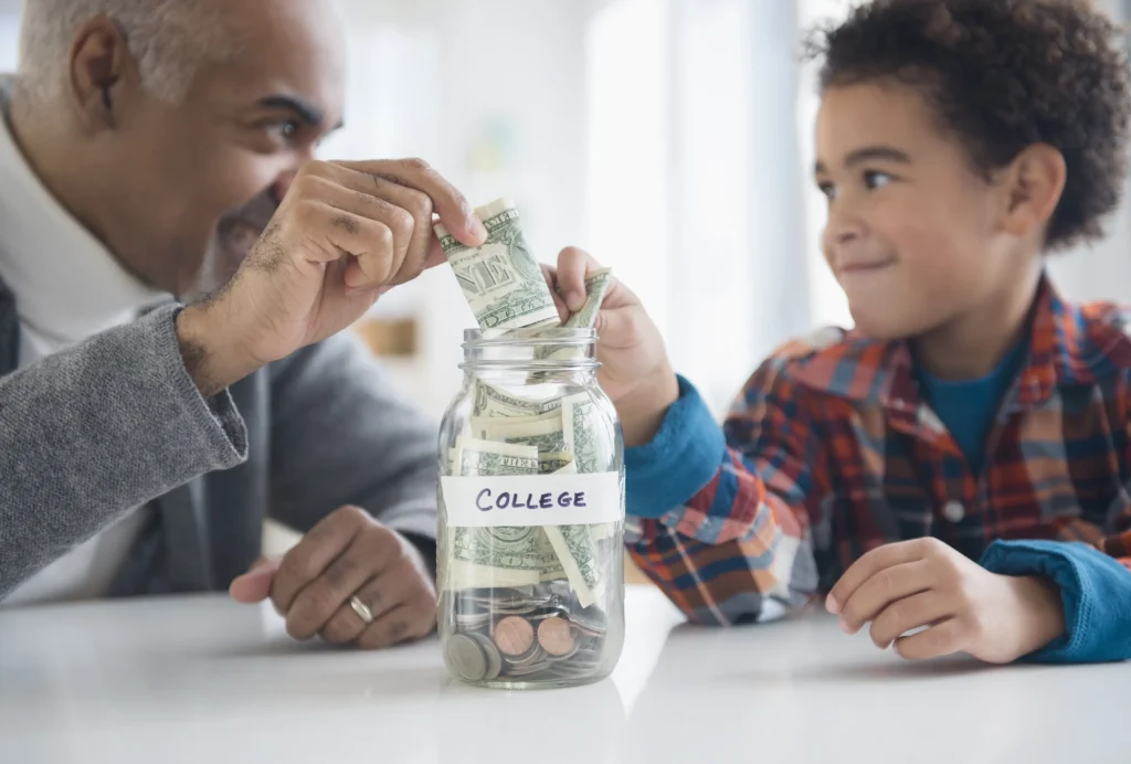 A man and a boy working together to build generational wealth by putting money into a jar.