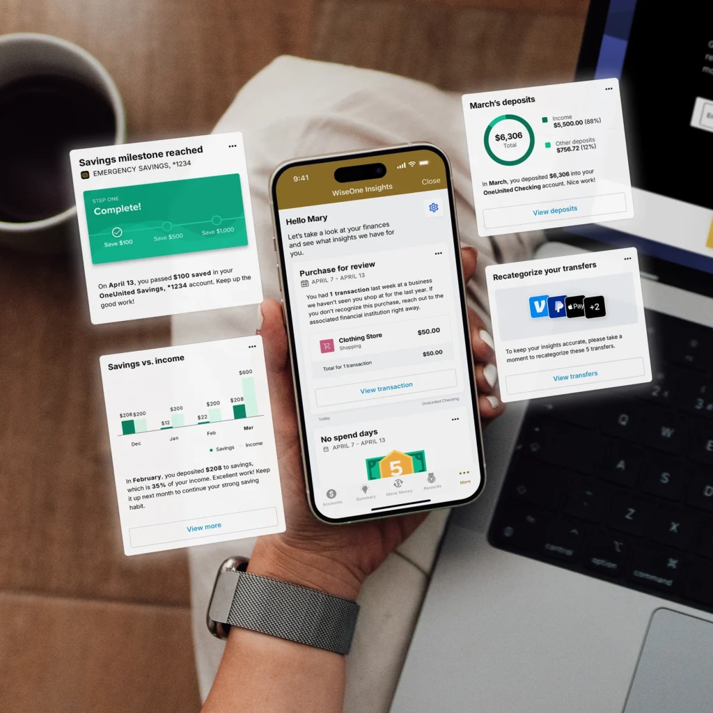 A person holding a smartphone displaying financial insights, surrounded by digital finance notifications, in front of an open laptop.