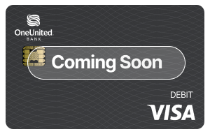 A OneUnited Bank debit Visa card with the words “Coming Soon” displayed across the center.