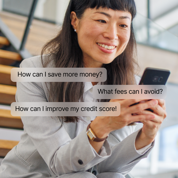 Woman in a suit sits on stairs, smiling while looking at her phone. Text bubbles read: "How can I save more money?", "What fees can I avoid?", and "How can I improve my credit score?.