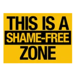 A yellow sign with black text reads, "THIS IS A SHAME-FREE ZONE," with "SHAME-FREE" highlighted in a black box.