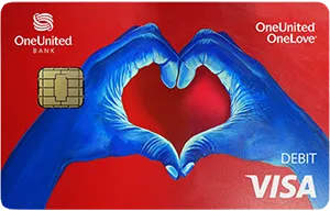 A OneUnited Bank debit card with two blue hands forming a heart shape on a red background. The card displays the Visa logo and chip.