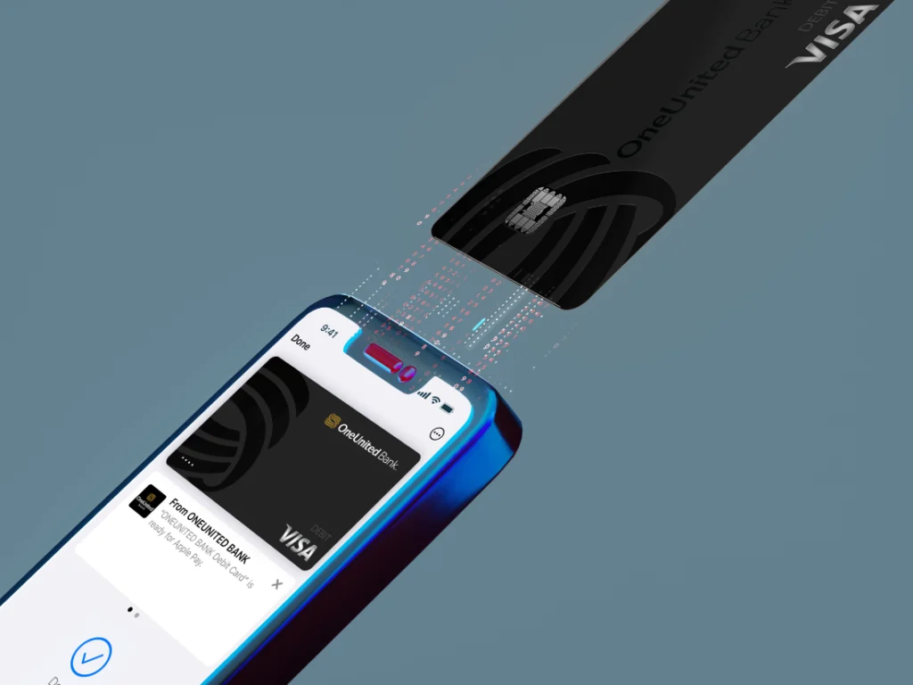 A black OneUnited Bank Visa card is being scanned over a smartphone, illustrating a digital payment or contactless transaction.